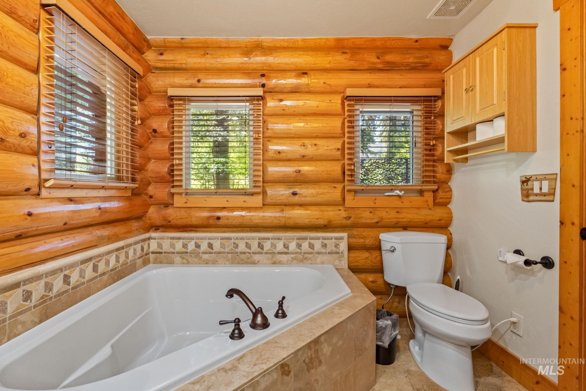 1160 Bell Flower Place McCall, ID 83638 - Photo 22 of 45 Full bathroom with a garden tub and log walls