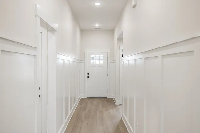 a view of a hallway with wooden shelves