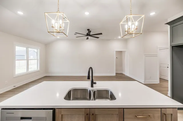 a kitchen with a sink and refrigerator