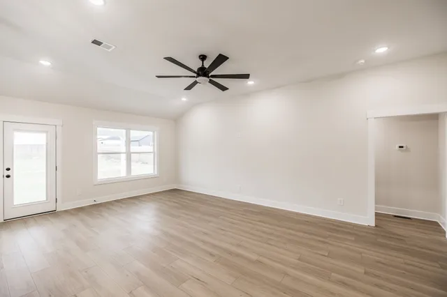 wooden floor in an empty room with a window
