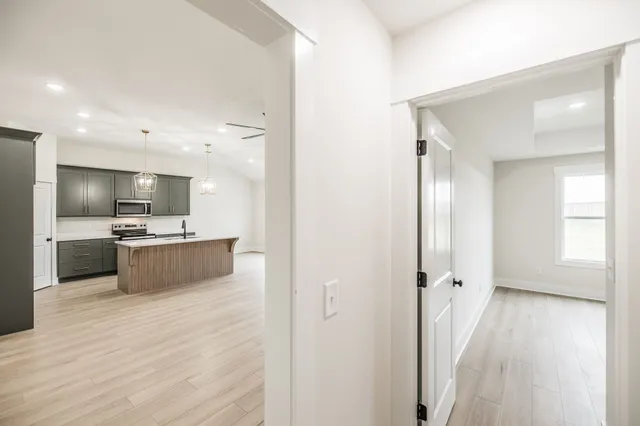 a large room with a lot of counter top space and stainless steel appliances