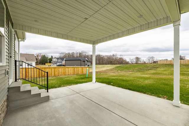 a view of a deck with a big yard