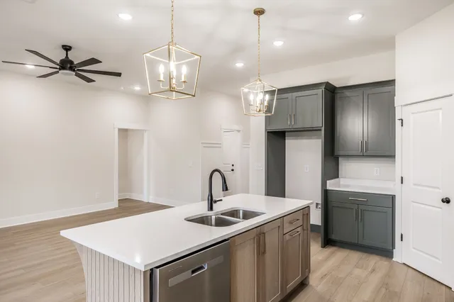 a kitchen with a sink a counter space cabinets and stainless steel appliances