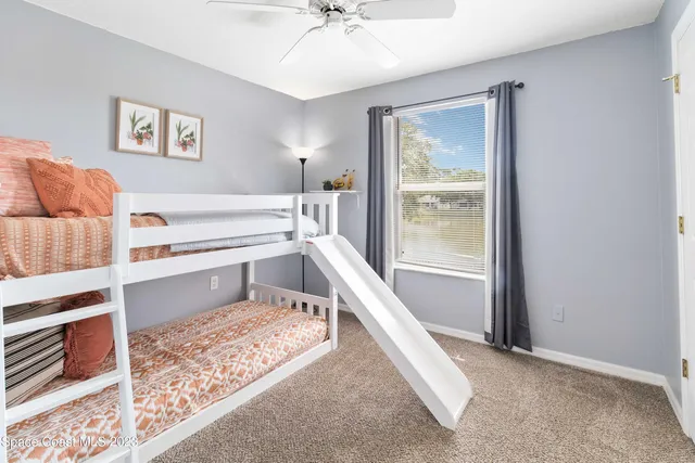 a view of a living room with a rug and a floor to ceiling window
