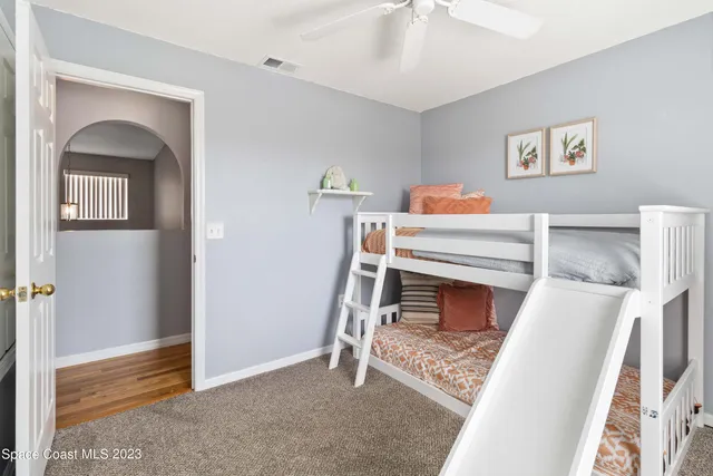 a living room with a bed and a fireplace