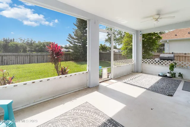 a view of a garden with wooden fence