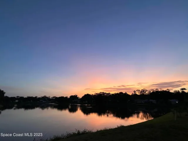 a view of outdoor space with green field and trees