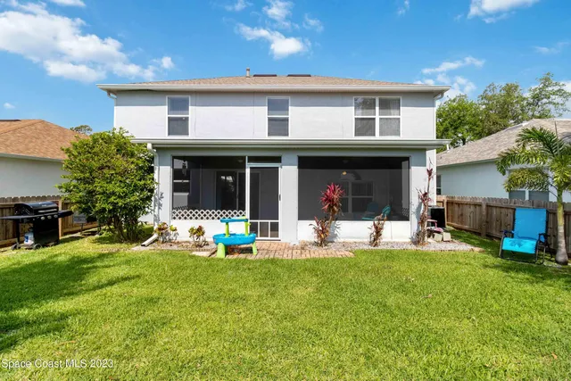 a view of a house with a yard and sitting area
