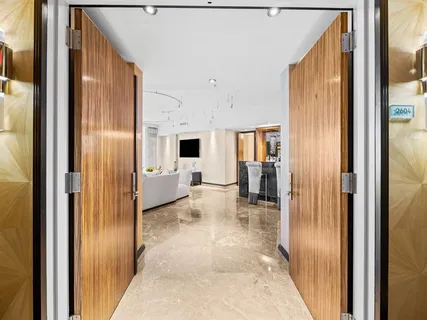 a view of a hallway with living room and dining room view