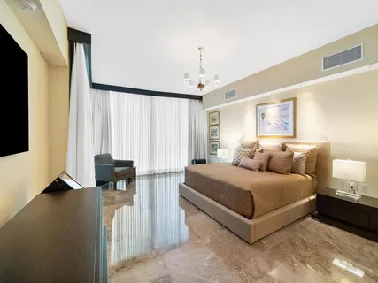 a spacious bedroom with a bed and a couch