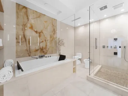 a bathroom with a bathtub and a shower
