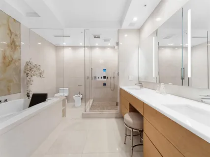 a bathroom with a granite countertop sink a toilet a tub and shower