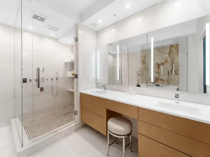 a bathroom with a shower sink and mirror