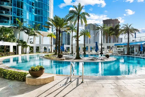 a view of a house with swimming pool and sitting area
