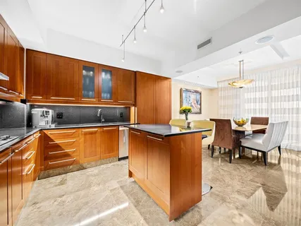 a kitchen with stainless steel appliances kitchen island granite countertop a sink and cabinets