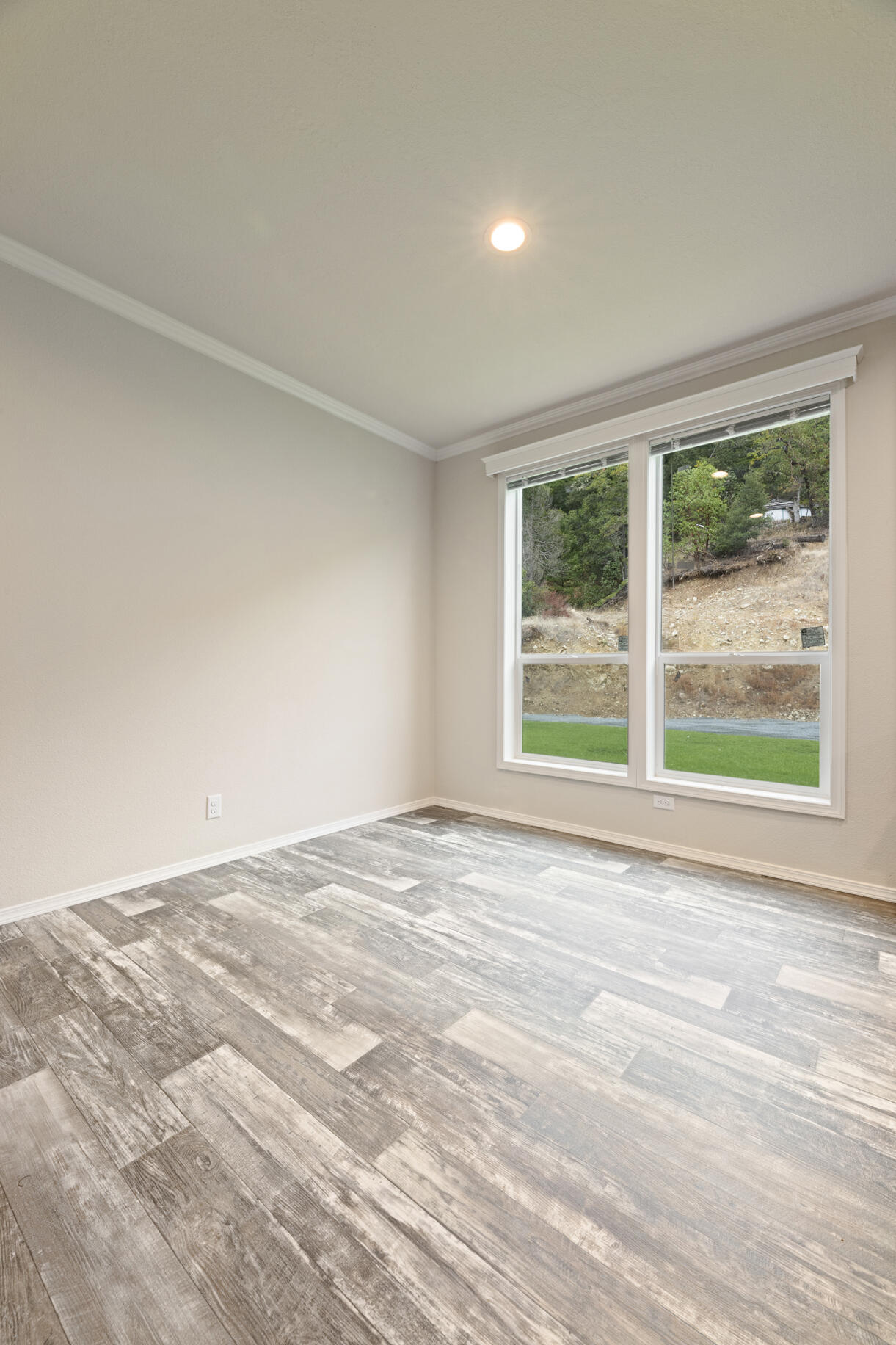 5572 Jumpoff Joe Creek Road Grants Pass, OR 97526 - Photo 10 of 38 a view of an empty room with wooden floor and a window