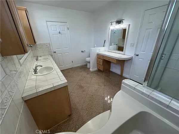 a bathroom with a bathtub shower sink and toilet