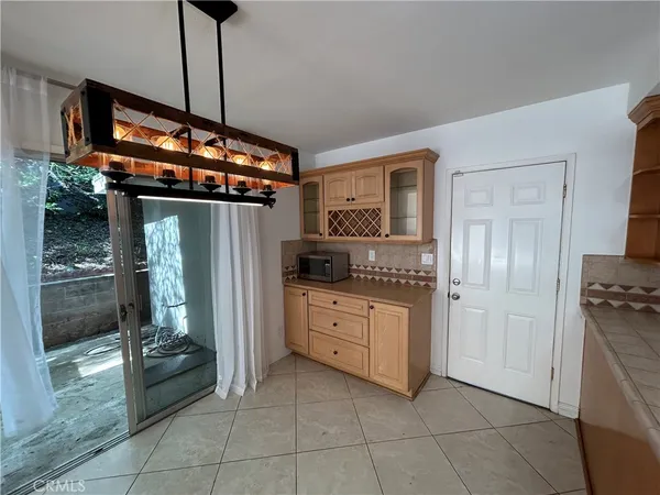 a kitchen with a sink a stove a microwave and cabinets
