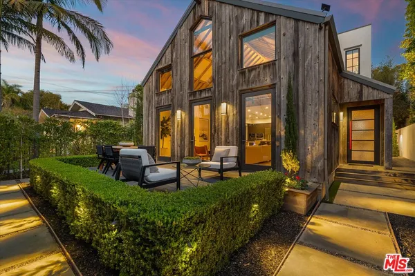 a view of a house with backyard swimming pool and sitting area
