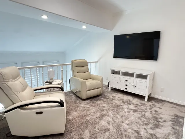 a bedroom with a bed and a tv on dresser