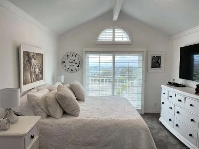 a bedroom with a bed and hallway