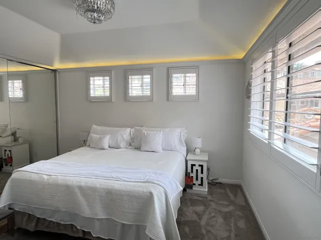 a view of a house with a large window and wooden floor