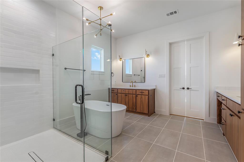 430 Whispering Way Red Oak, TX 75154 - Photo 40 of 40 Glass-enclosed shower featuring white subway tile, a built-in niche, and a linear drain