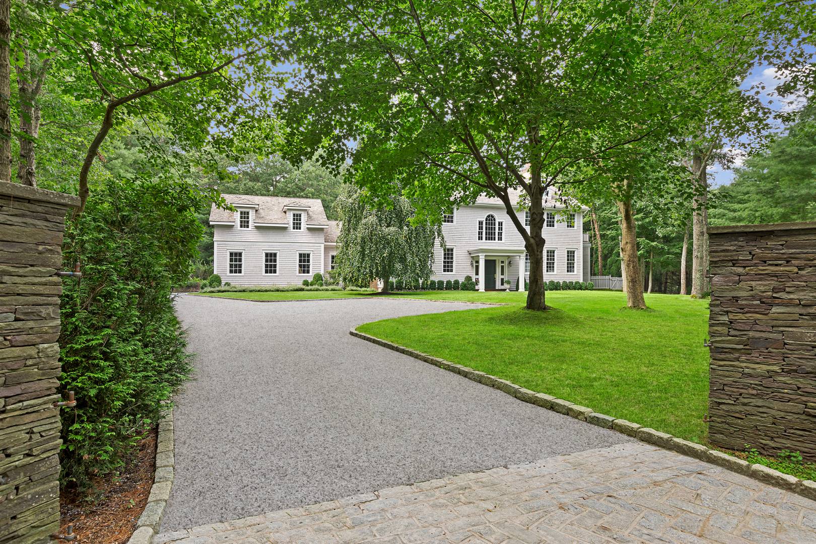 33 Cedar Trail East Hampton, NY 11937 - Photo 3 of 30 a front view of a house with garden