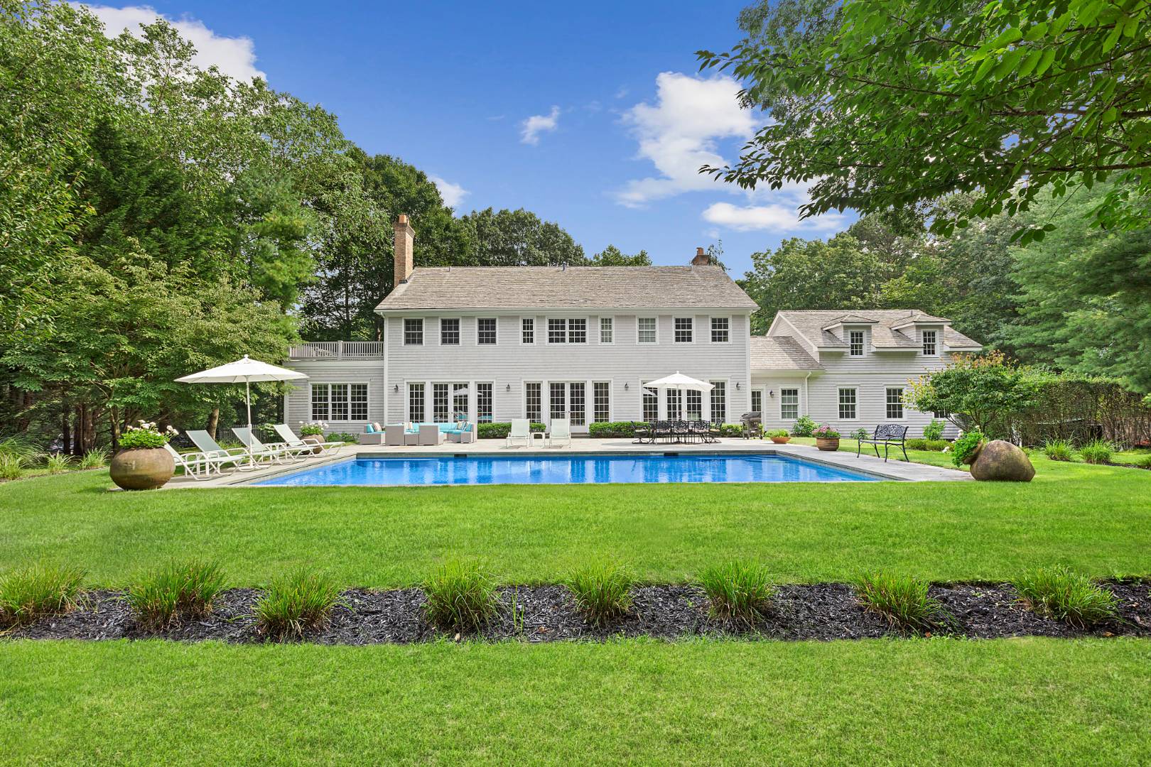 33 Cedar Trail East Hampton, NY 11937 - Photo 27 of 30 a view of a house with backyard and sitting area