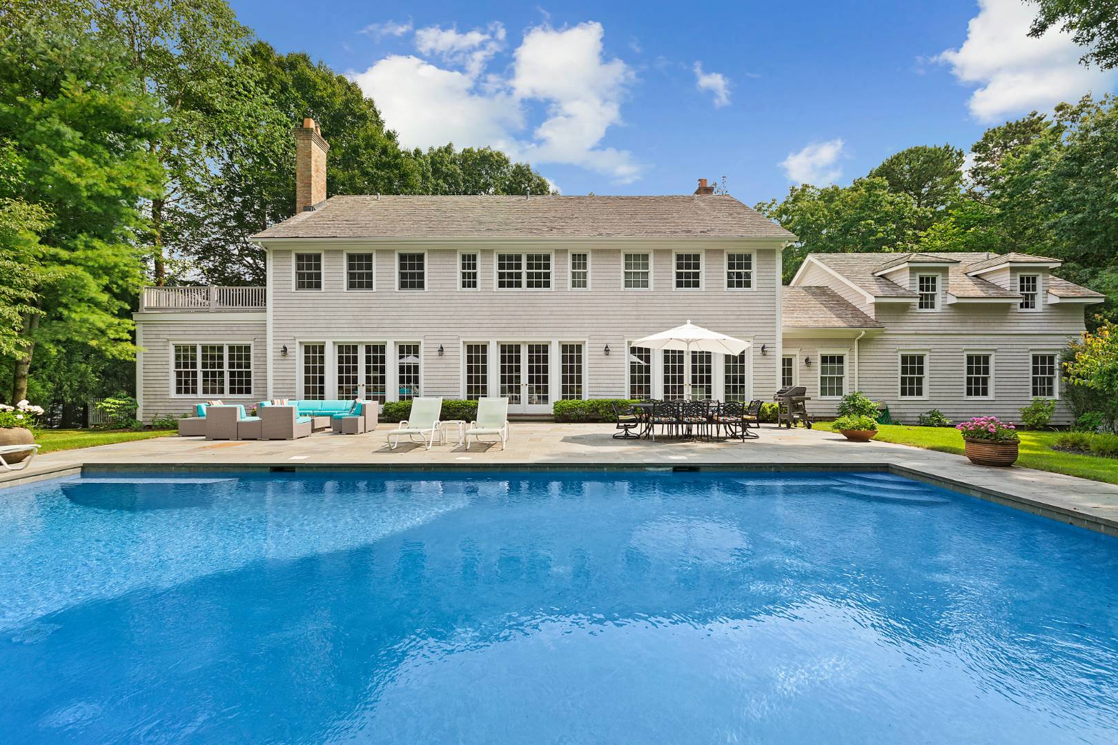 33 Cedar Trail East Hampton, NY 11937 - Photo 30 of 30 a front view of a house with swimming pool and porch