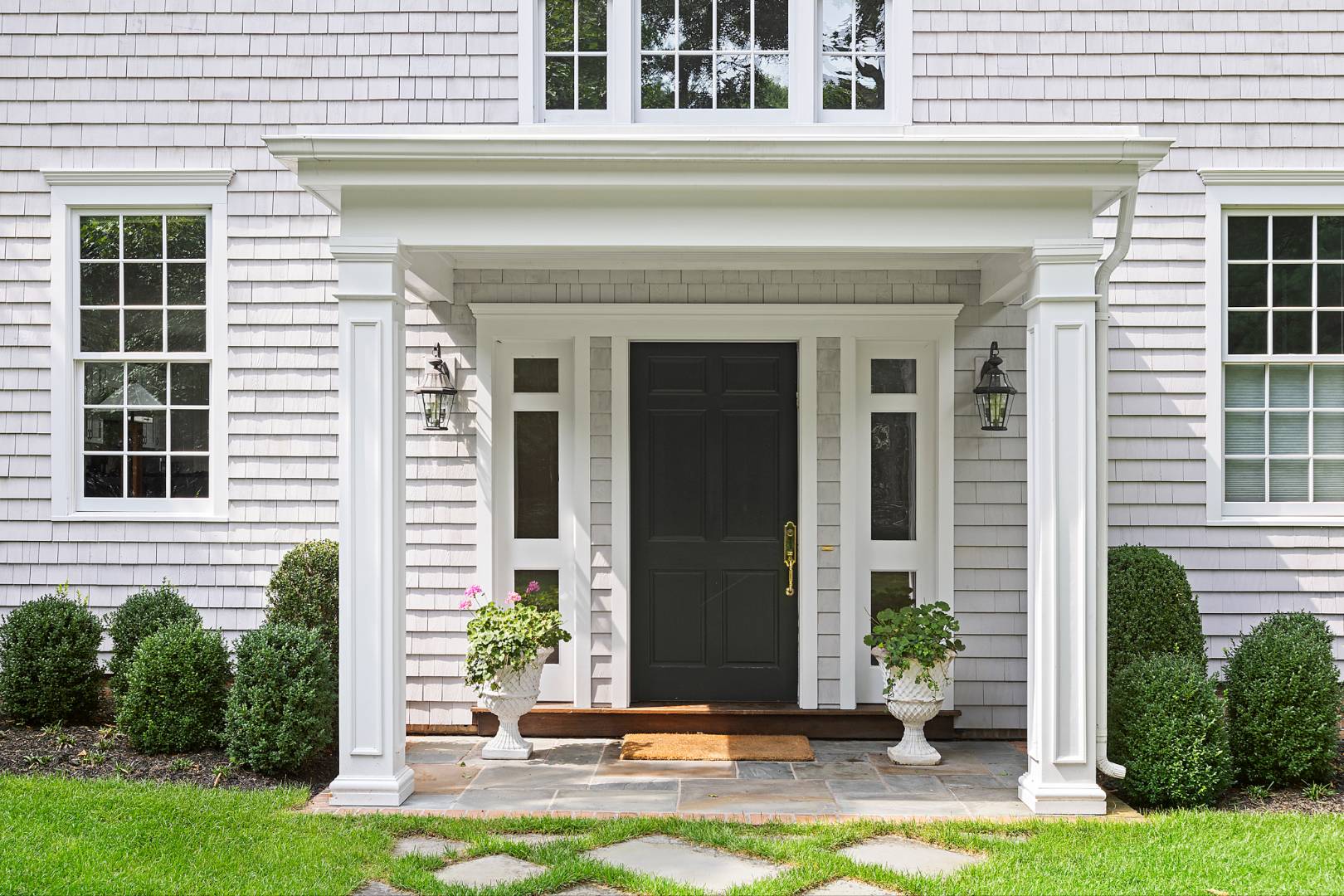 33 Cedar Trail East Hampton, NY 11937 - Photo 5 of 30 a front view of a house with a yard and garage
