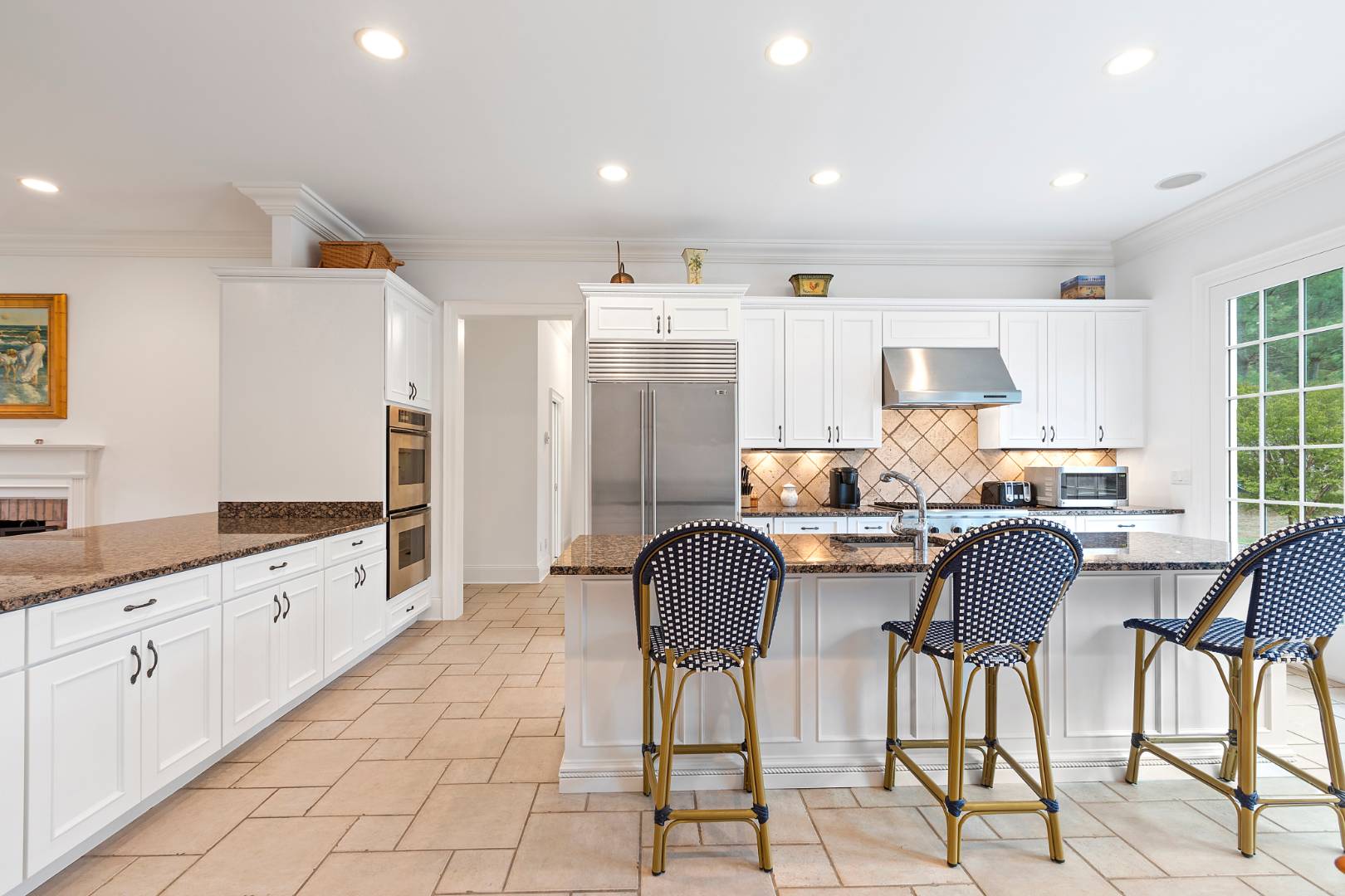 33 Cedar Trail East Hampton, NY 11937 - Photo 8 of 30 a kitchen with granite countertop white cabinets and stainless steel appliances