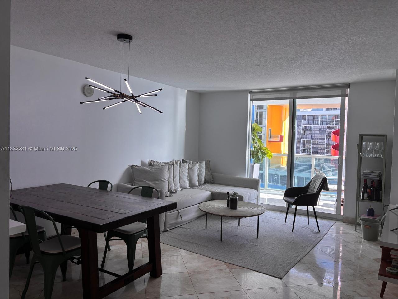 2101 Brickell Avenue, Unit 903 Miami, FL 33129 - Photo 11 of 22 a living room with furniture and a window
