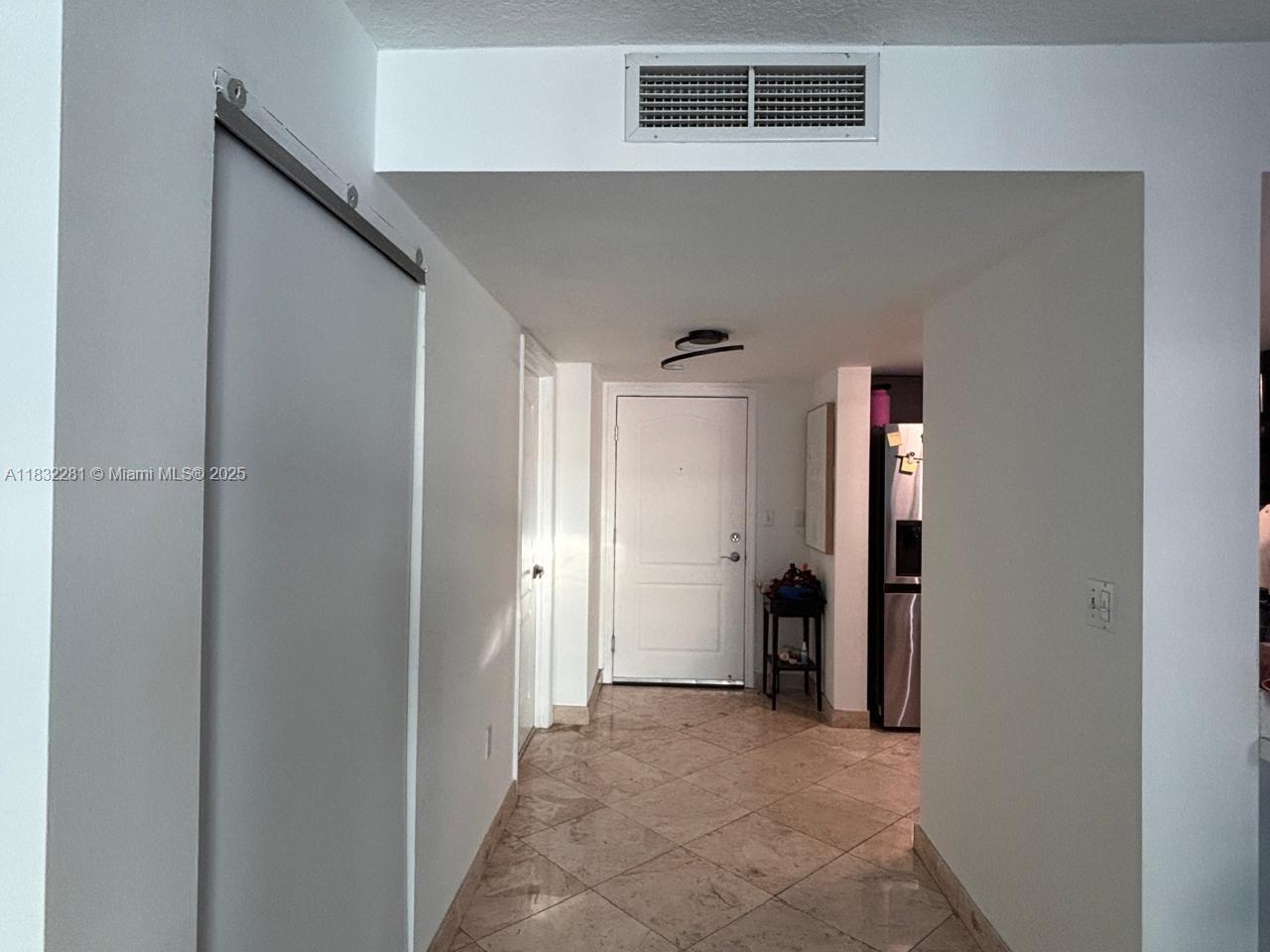 2101 Brickell Avenue, Unit 903 Miami, FL 33129 - Photo 22 of 22 a view of a hallway to closet and a bathroom
