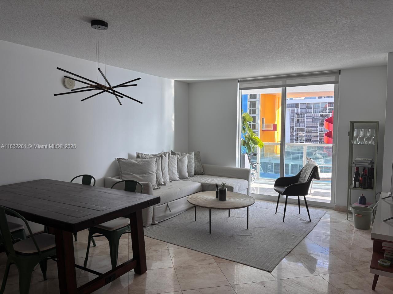 2101 Brickell Avenue, Unit 903 Miami, FL 33129 - Photo 9 of 22 a living room with furniture and a window