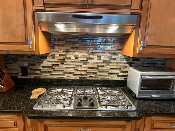 a stove top oven sitting inside of a kitchen