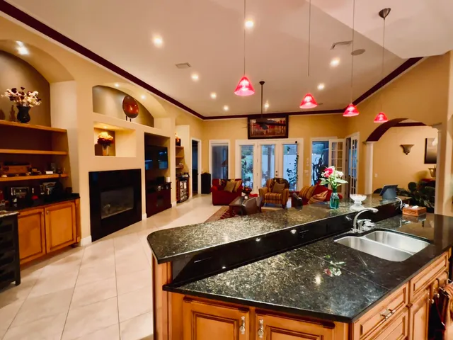 a large kitchen with stainless steel appliances granite countertop a large counter top and stove
