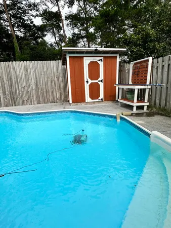 a backyard of a house with table and chairs
