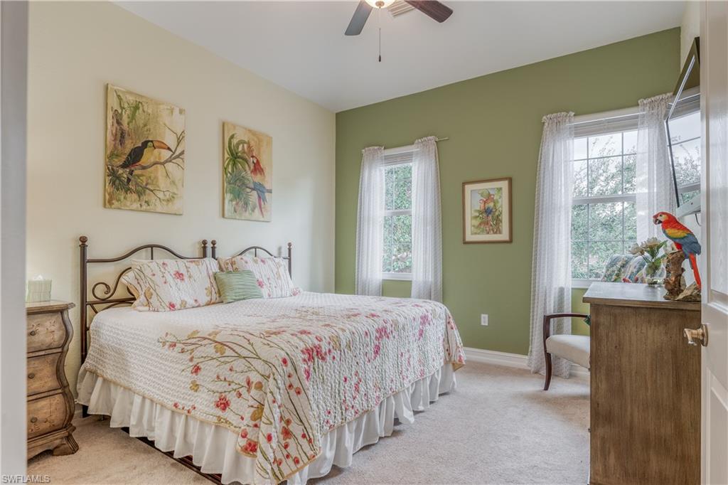 6017 Trophy Drive, Unit 603 Naples, FL 34110 - Photo 11 of 23 a bedroom with a bed and a painting on the wall