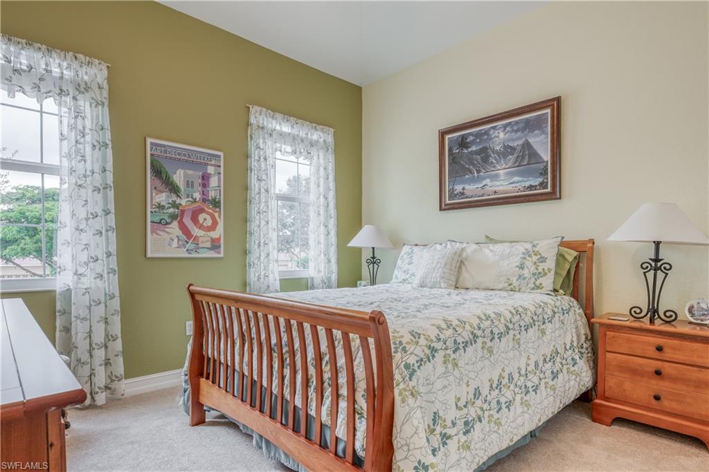 6017 Trophy Drive, Unit 603 Naples, FL 34110 - Photo 12 of 23 a bedroom with a bed and a painting on the wall