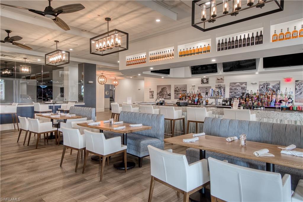 6017 Trophy Drive, Unit 603 Naples, FL 34110 - Photo 21 of 23 a dining table with chairs and a clock on the wall