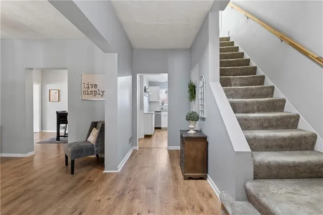 a view of entryway and hall with wooden floor