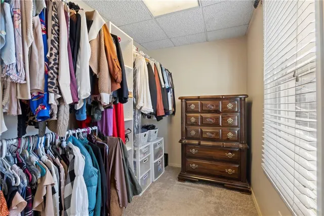 a bedroom with furniture and a large window