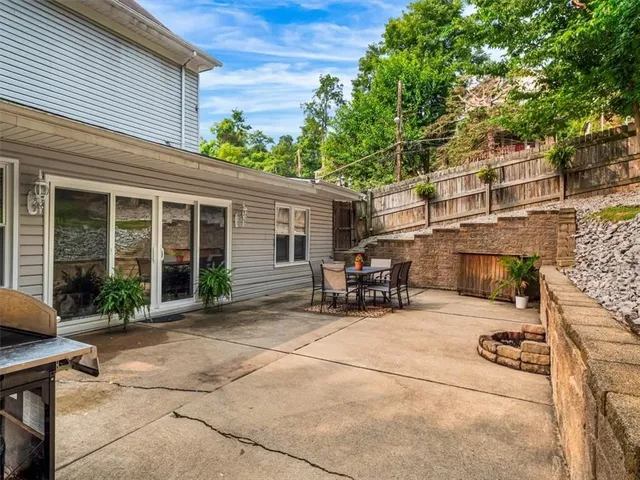 a view of a house with a yard and sitting area