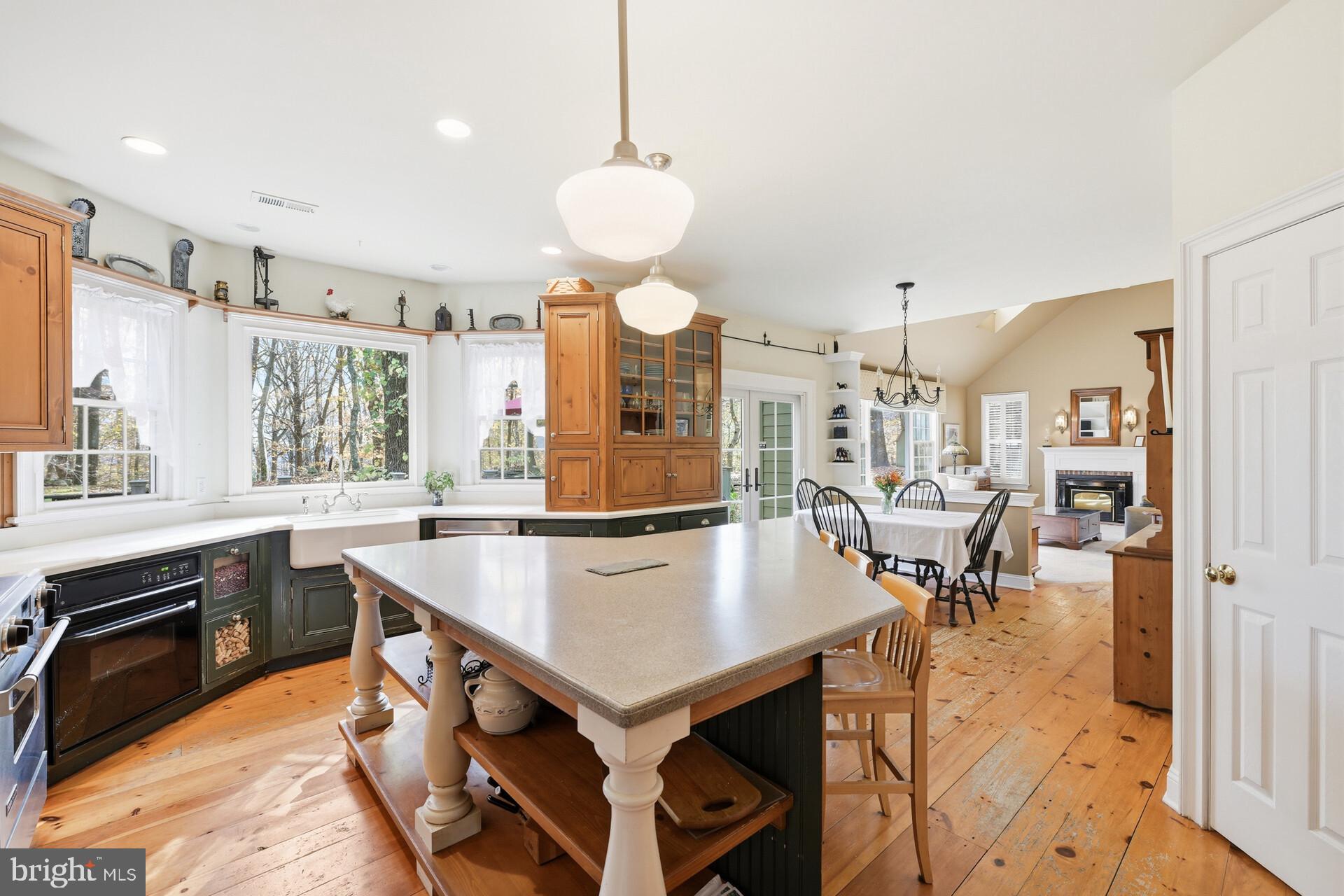 6950 Upper York Road New Hope, PA 18938 - Photo 13 of 60 a large kitchen with kitchen island a table and chairs in it