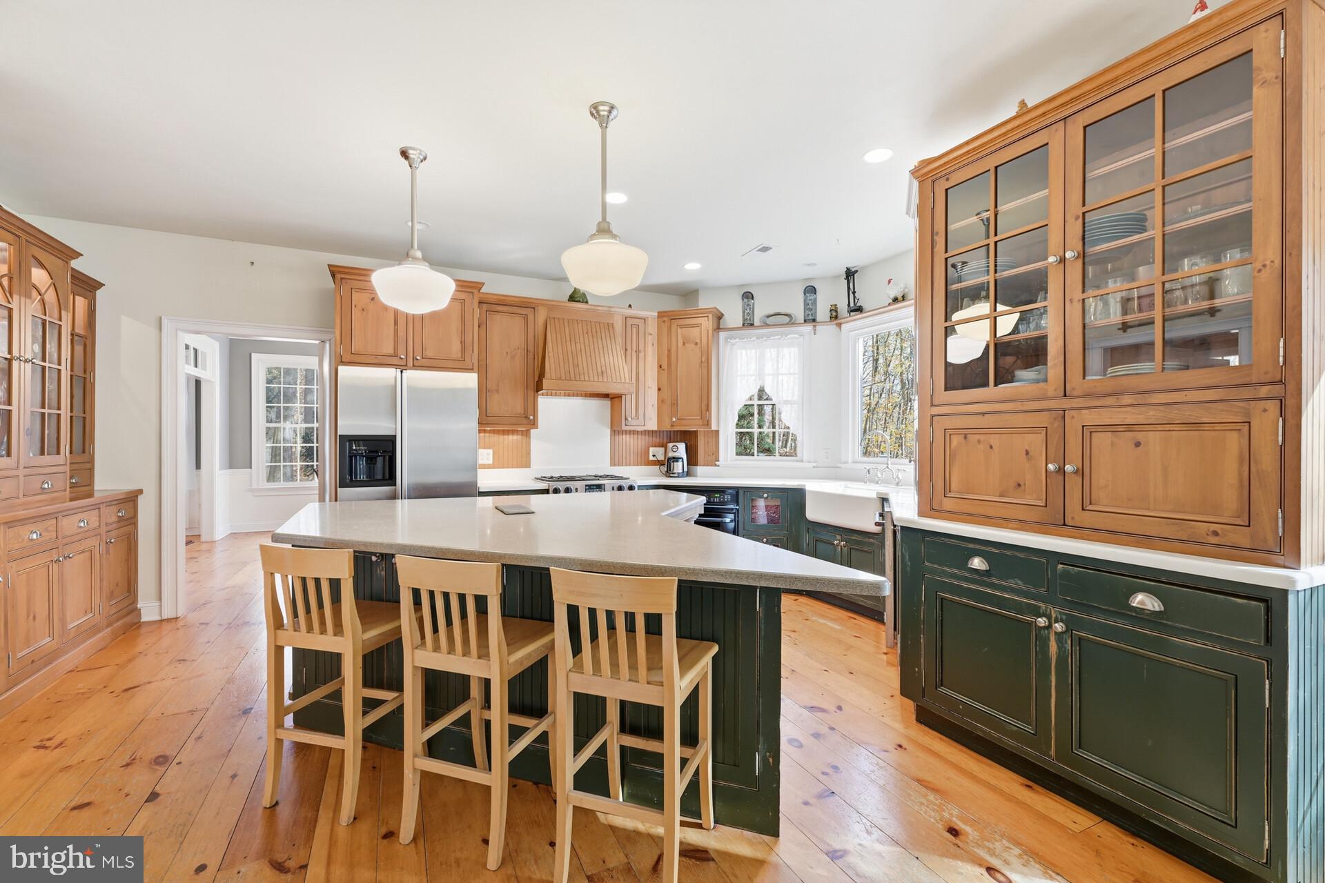 6950 Upper York Road New Hope, PA 18938 - Photo 16 of 60 a kitchen with a table chairs stove and cabinets