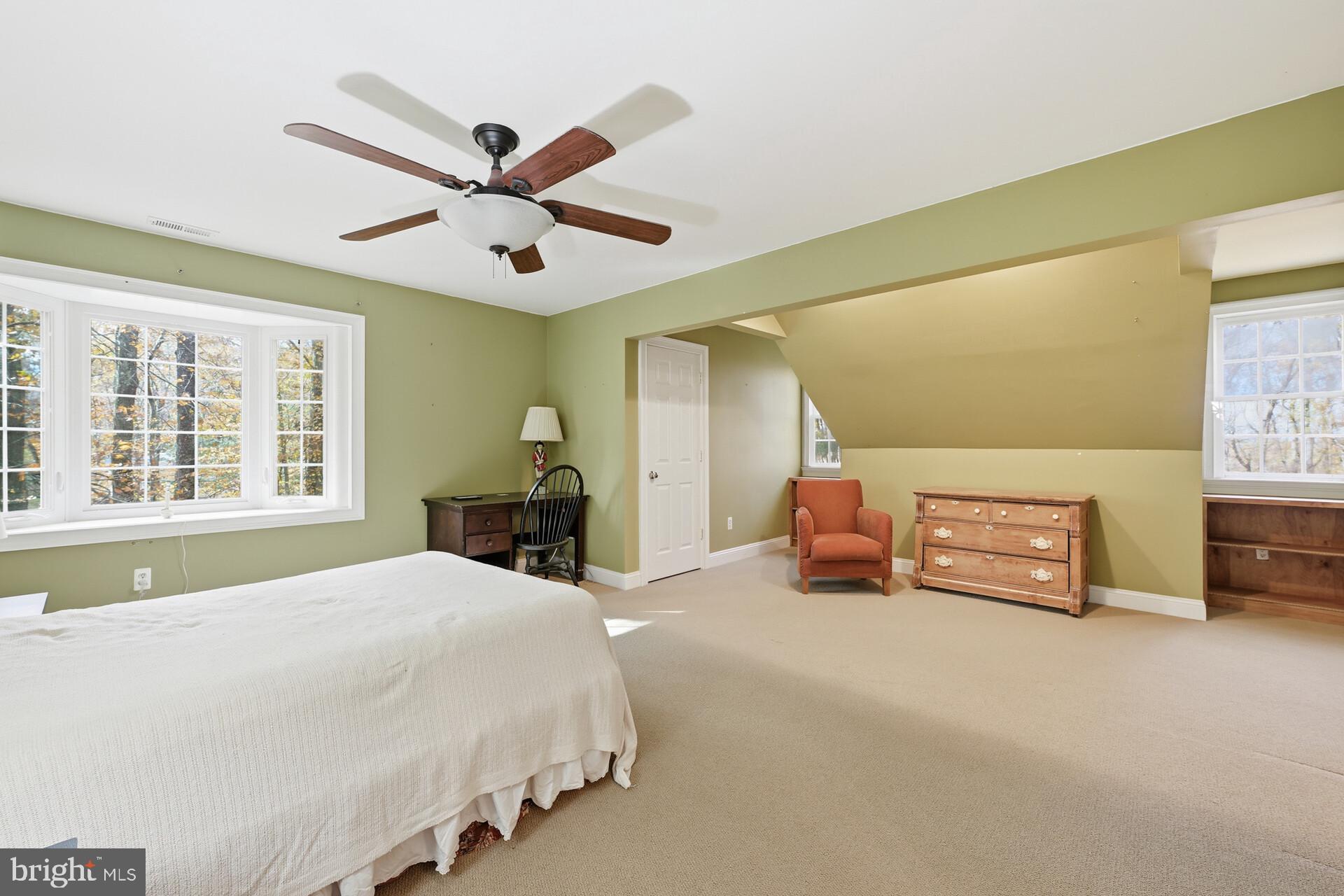 6950 Upper York Road New Hope, PA 18938 - Photo 33 of 60 a bedroom with a bed and a chandelier