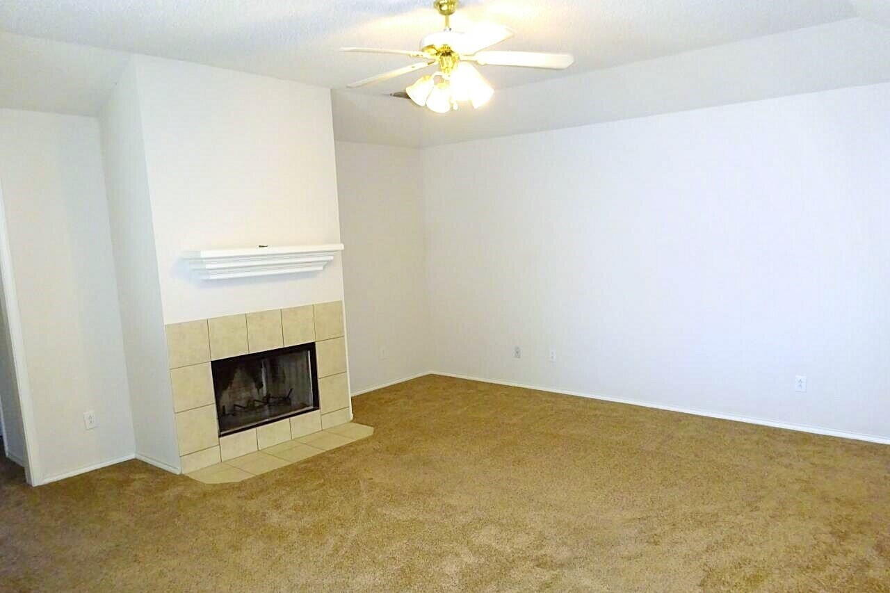 10108 Evanston Avenue, Unit 2 Lubbock, TX 79424 - Photo 2 of 8 a view of empty room with a fireplace