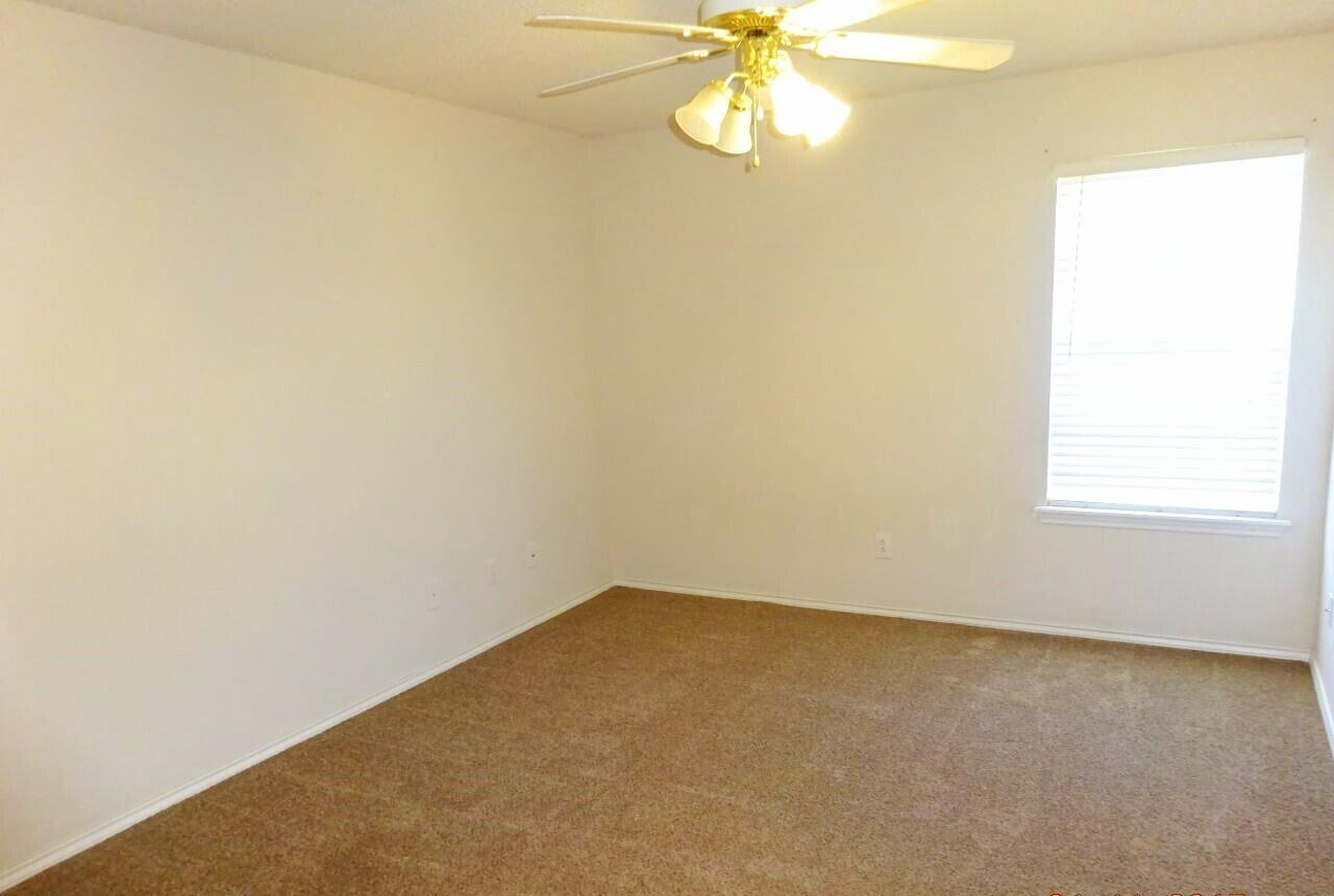 10108 Evanston Avenue, Unit 2 Lubbock, TX 79424 - Photo 5 of 8 an empty room with a window
