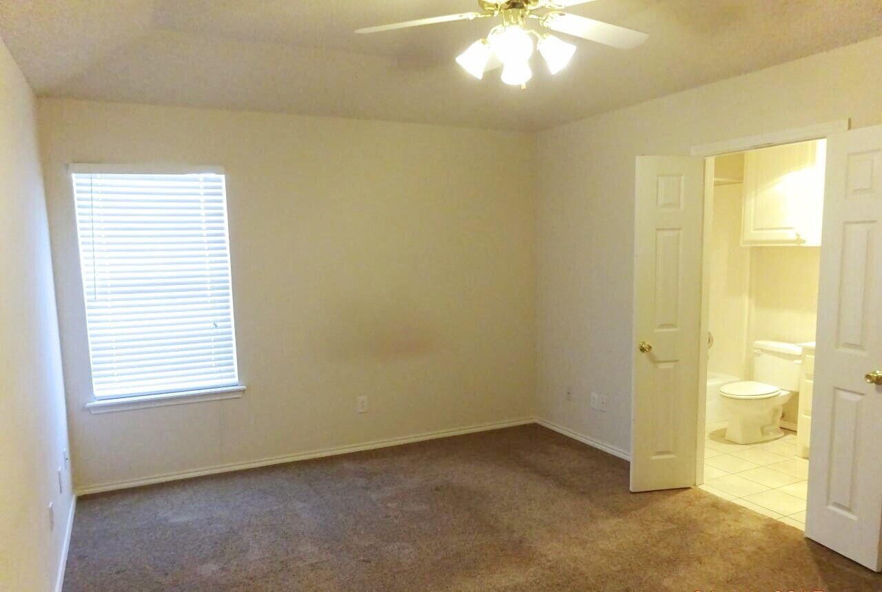 10108 Evanston Avenue, Unit 2 Lubbock, TX 79424 - Photo 7 of 8 a view of an empty room with a window